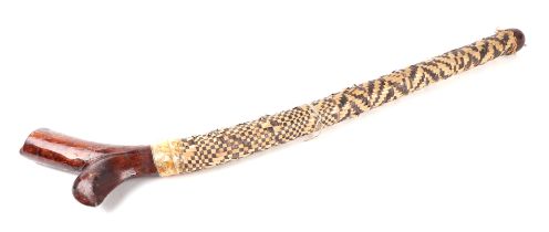 An Oceanic tribal club, possibly Polynesian, with rattan covered shaft, 95cms long.