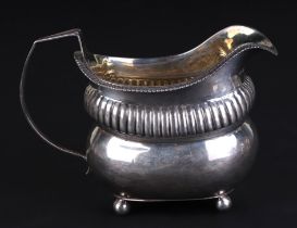 A George III silver milk jug, London 1812 and maker's mark for Thomas Daniell, 9.5cms high, 153g.