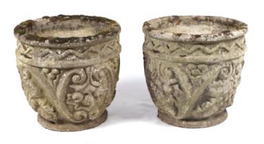 A pair of well weathered reconstituted stone circular planters, 40cms wide (2).