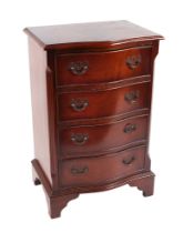A Georgian style mahogany serpentine fronted chest of four long drawers, of small proportions, on