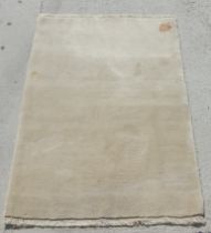 A beige ground Persian Gabbeh rug, 150 by 100cms.