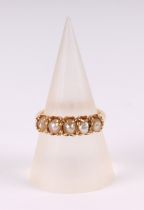 A Victorian yellow metal and seed pearl half-hoop ring, 3g, approx UK size L.