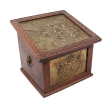 An oak log box with brass panels depicting tavern scenes, 48cms wide.