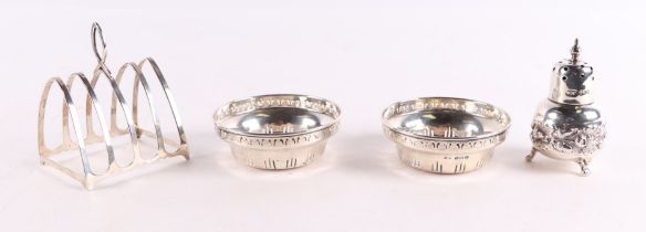 A pair of small pierced silver bowls; together with a silver pepper and a silver four-division toast