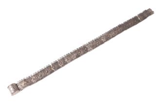 An Indian silver coloured metal articulated belt, 75cms long.