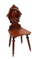 A continental oak hall chair, the back panel carved with a classical warrior.