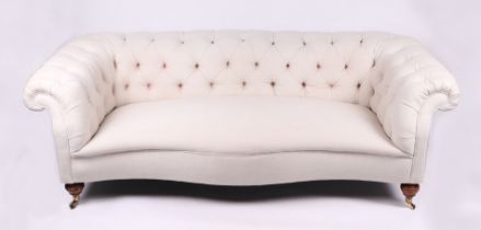 A Chesterfield cream upholstered three-seater sofa on turned front legs, approx 190cms wide.