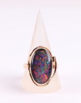 A 9ct gold ring set with a large oval opal doublet, approx UK size 'S', 5.8g.