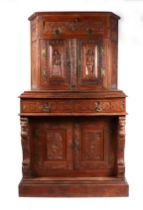 A 19th century carved oak cupboard, the superstructure with canted corners, the fall-flap frieze