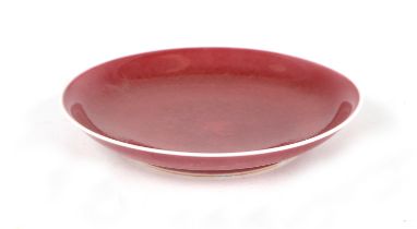 A Chinese monochrome red glazed saucer dish, 14.5cms wide.