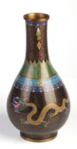 A Chinese cloisonné vase decorated with dragons chasing a flaming pearl, on a black ground, 22cm