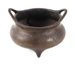 A Chinese bronze tripod censer with loop handles, cast six-character mark to the base, 12.5cms