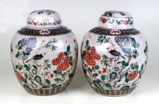 A pair of Chinese famille rose crackle ware ginger jars and covers decorated with birds amongst
