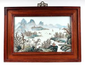 A Chinese rectangular porcelain plaque depicting a river landscape scene, framed, 42 by 26cms.
