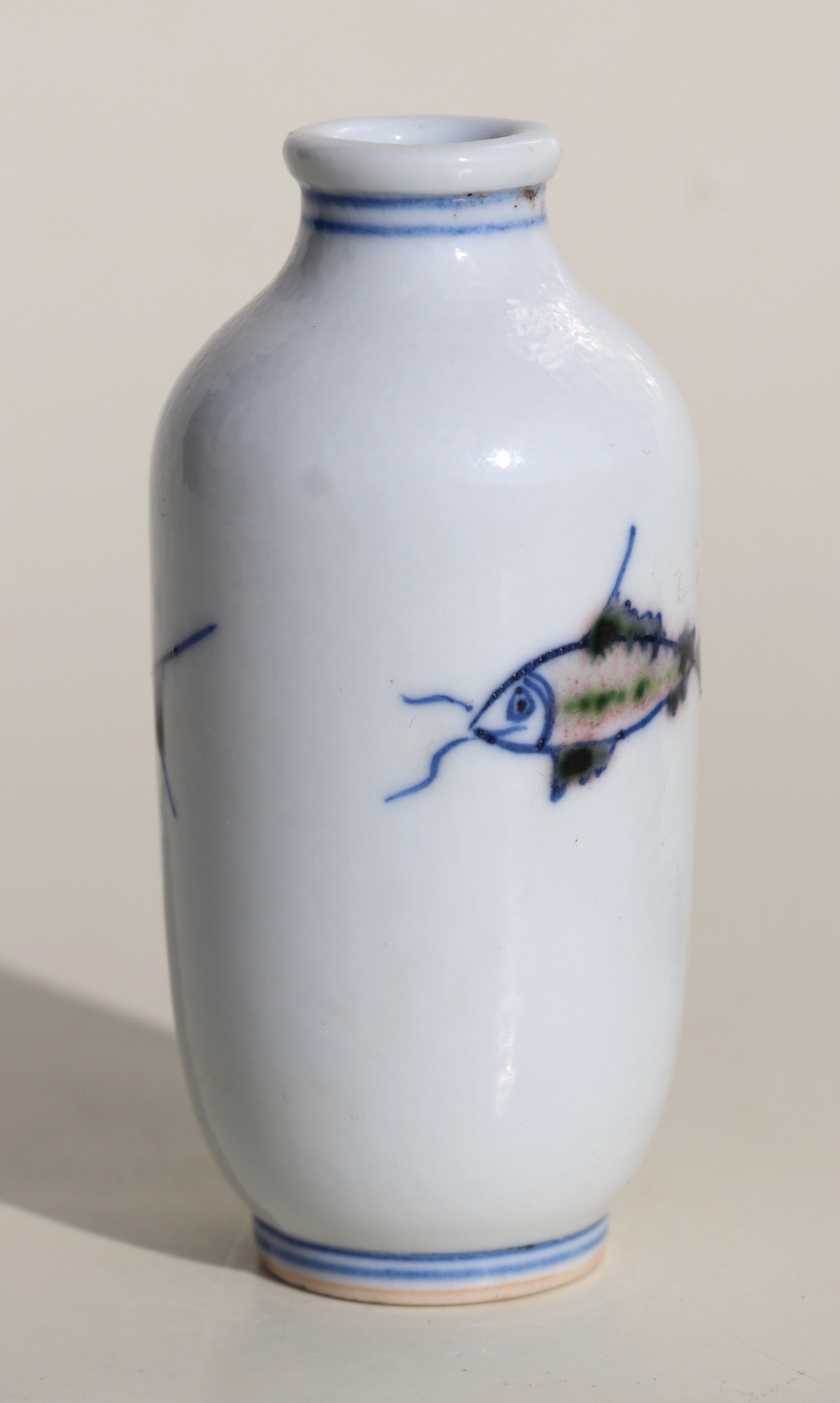 A Chinese porcelain snuff bottle decorated with fish, on a hardwood stand, 7.5cms high. Condition - Image 2 of 6