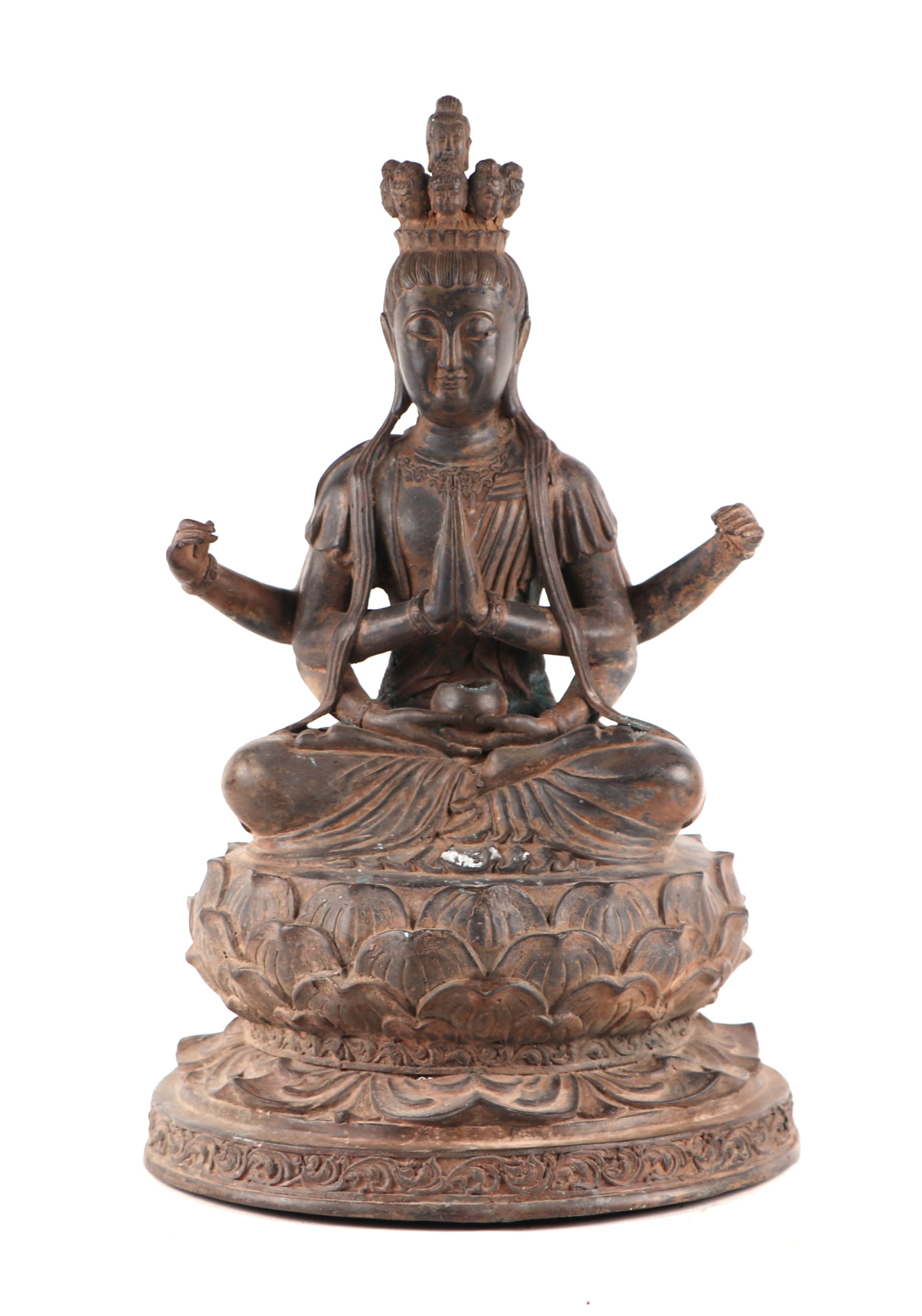 A large patinated metal multi-armed deity seated on a lotus flower, 38cms high.