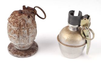 An inert Mills Bomb hand grenade stamped with a "K" and mounted on a metal base, together with