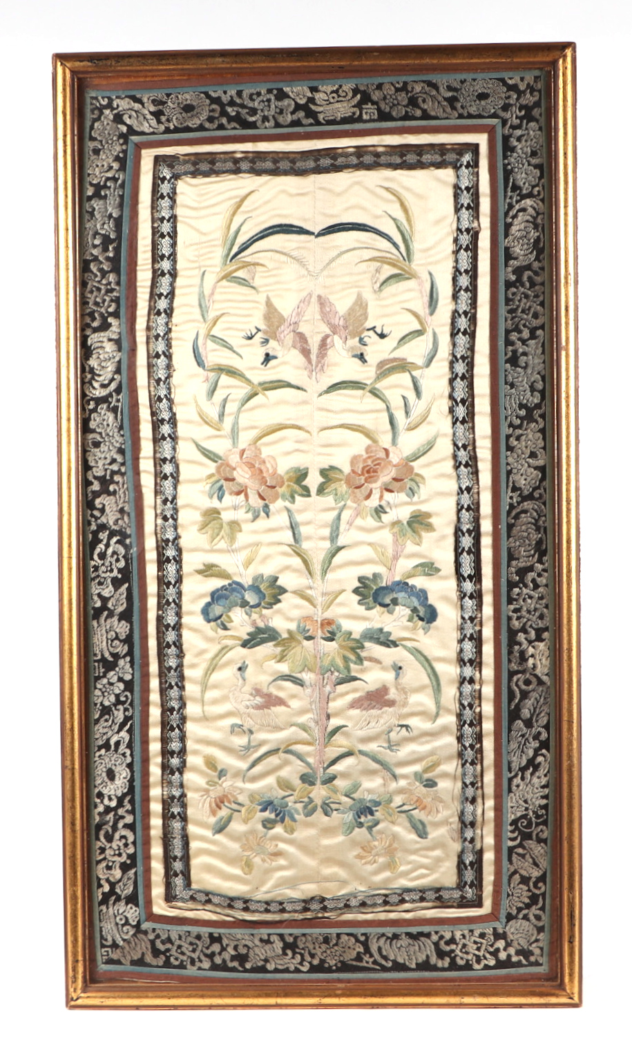 A Chinese silk embroidered sleeve panels decorated with birds amongst foliage, framed & glazed, 32
