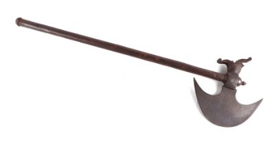 An Indian axe with engraved crescent form axe head, 76cms long.