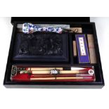 A Chinese calligraphy set to include an ink stone carved with a dragon, a famille rose porcelain