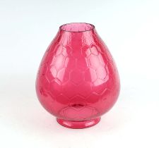 An oversized cranberry glass oil lamp shade with honeycomb design, 31cms high.