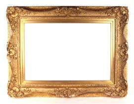 A gilt gesso rococo style picture frame, 93 by 72cms, window size 68 b7 46cms.