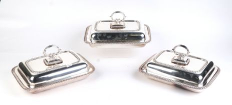 A set of three George III style silver plated entrée dishes and covers of rectangular form with
