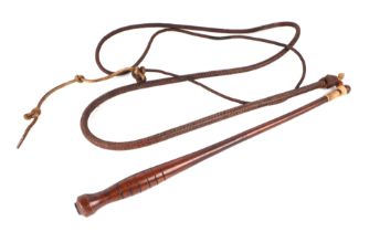 A leather bull whip with treen handle.