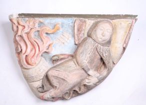 A 1920's polychrome plaster wall hanging decorated in deep relief depicting a woman with a basket of