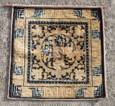 A Chinese Ningxia meditation mat with central floral design on a beige ground, 69 by 69cms.