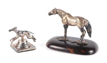 An Edwardian silver model of a pony on a tortoiseshell base, London 1909, 6cms high; together with a