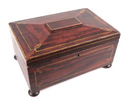 A 19th century faux rosewood workbox of sarcophagus form, on bun feet, 31.5cms wide.