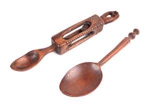 A Welsh carved wooden love spoon, 20cms long; together with another carved wooden spoon with seal