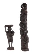 An African carved hardwood fertility figure depicting a lady carrying a child with a basket on her