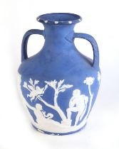 A Jasperware style Portland vase decorated with classical figures, 28cms high.