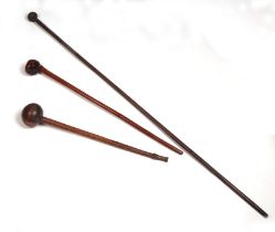 An African Zulu hardwood knobkerry, 60cms long; together with another similar, 75cms long; and a