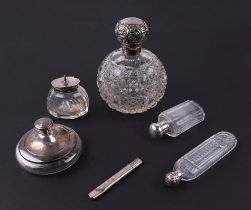 A silver topped cut glass scent bottle of globular form; together with two silver topped scent