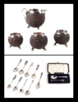 Three white metal mounted coconut cups and matching jug; together with a boxed silver fork & spoon