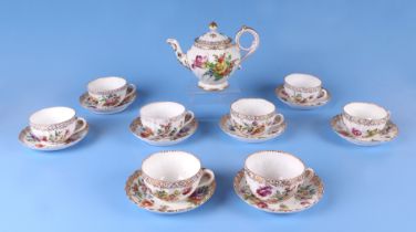 Eight Dresden cups and saucers decorated with flowers, together with a similar Dresden teapot.