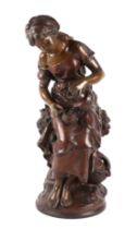 A late 19th century bronzed spelter figure of a young woman pouring a drink, 45cms high.