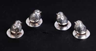 A set of four Sampson Morden menu holders in the form of a chick emerging from an egg, two Chester
