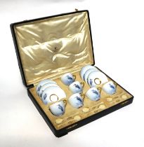 A Royal Worcester six-person coffee set decorated with cranes on a blue ground (lacks spoons),