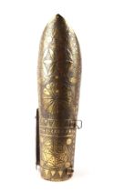A North Indian brass arm guard decorated with roundels and script, 34cms long.