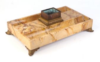 A late 19th century Sienna marble desk stand with twin pen recesses and bronze lion paw feet,