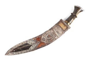 An Indian kukri with ornate white and yellow metal mounted leather scabbard and horn handle, 48cms