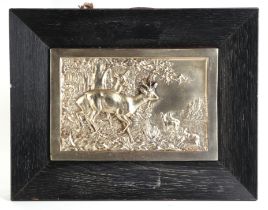 A cast metal plaque depicting a deer in woodland, framed, 25 by 17cms.