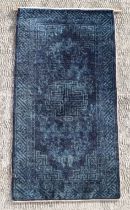 A Chinese Ningxia rug, the central medallion within stylised borders on a blue ground, 105 by