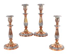 A set of four late 19th century Sheffield plate candlesticks, each with baluster form reeded columns