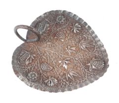 An Indian white metal dish decorated in relief with flowers, 15cms wide, 172g.
