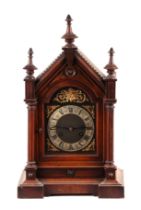 An Edwardian walnut architectural mantle clock, the brass dial with silvered chapter ring and